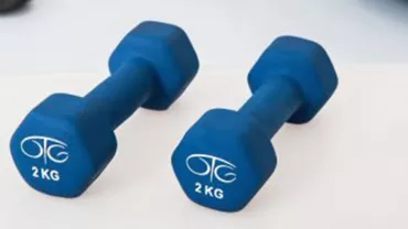 Par de mancuernas azules de 2 kg cada una sobre una superficie blanca.