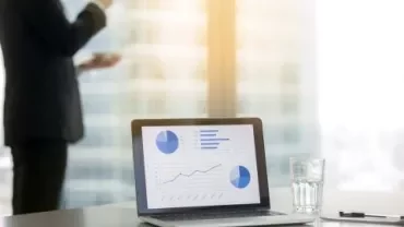 Portátil con gráficos de negocio en una oficina moderna.