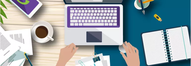 Vista superior de un escritorio con laptop, cuaderno, gráficos y taza de café.