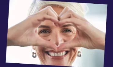 Woman doing a heart-shaped gesture with hands