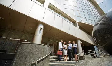 People greeting on the entrance of a building