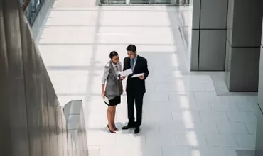 Executive man making questions a woman for something